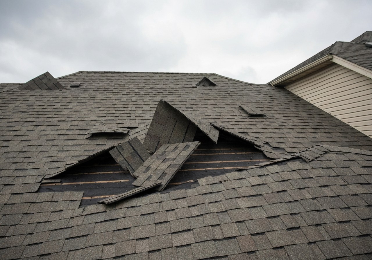 Wind-lifted shingles on a Katy-area roof after a storm