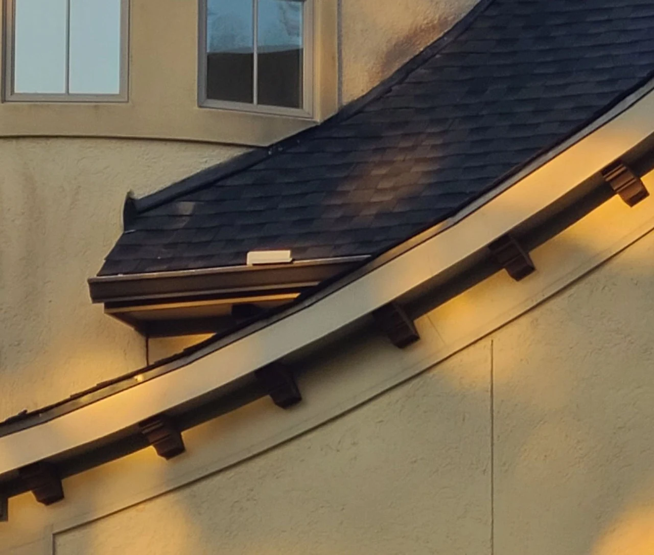 Soffit and fascia repair - curved fascia board, decorative corbels and the soffit underside along a roof edge on a Blue Rhino Roofing project